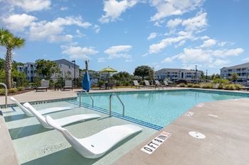 Resort style swimming pool is next to our building with apartment buildings in the background